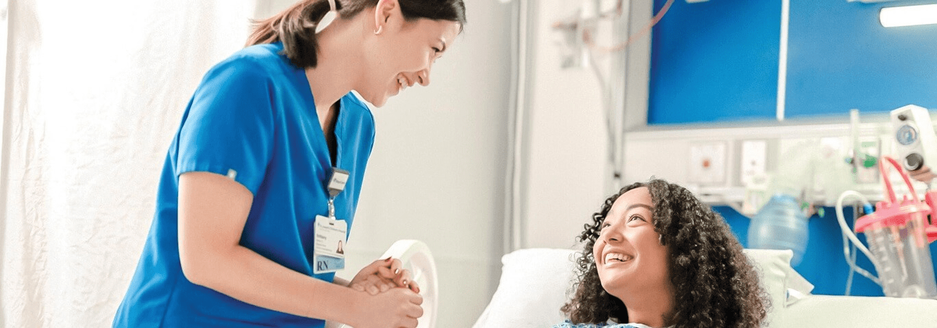 A nurse provides care to a patient in a hospital bed, highlighting the commitment to patient safety at BayCare.