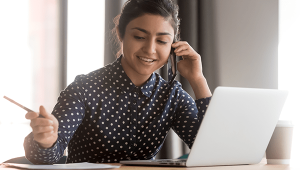 connect with a health care navigator Woman on the phone applying for financial assistance