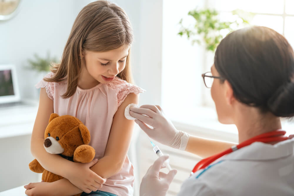 physician comforting child who had a vaccine