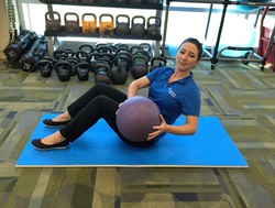A woman demonstrates the Russian Twist exercise.