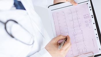A doctor is checking the heart rhythm of a patient.
