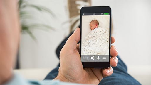 A relative uses NICU Baby Watch to view the family's new baby on his mobile device during a scheduled viewing appointment.