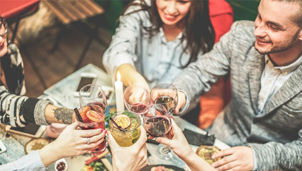 group of friends toasting at a dinner table