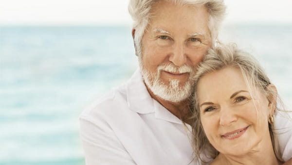 mature couple hugging on the beach