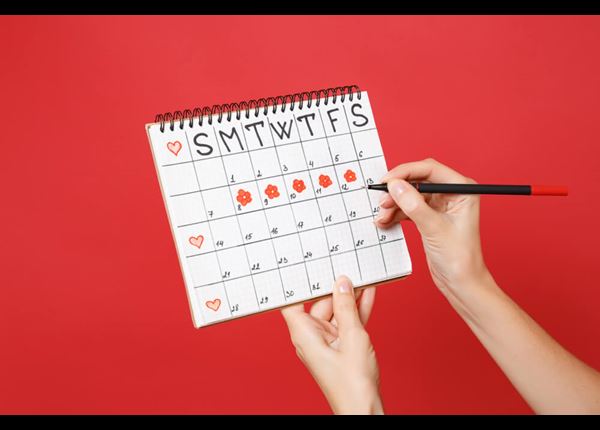 woman pointing to a calendar