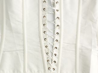 fragment of a white satin corset with lacing, wrong side of clothes