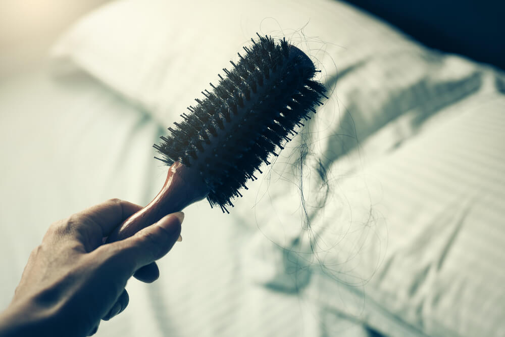 woman holding out a hair brush
