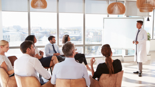 Doctor giving a lecture to medical staff in a hospital setting. 