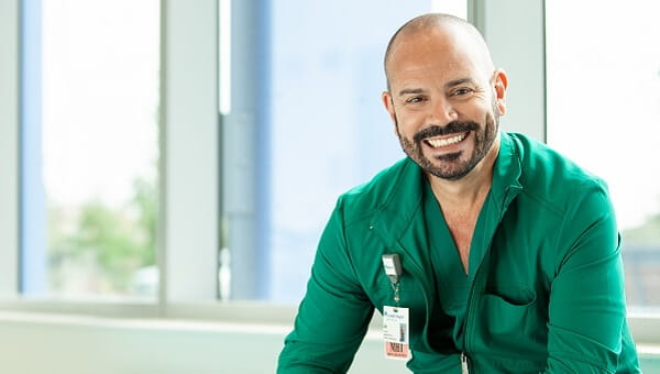 abniel garcia smiling and wearing green scrubs