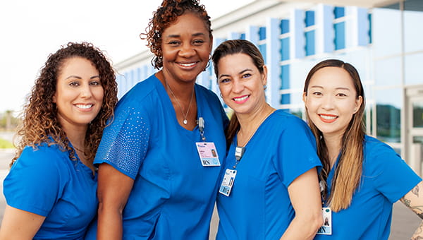 team of four female clinicians standing outside of a baycare hospital