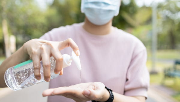 man using hand sanitizer man using hand sanitizer
