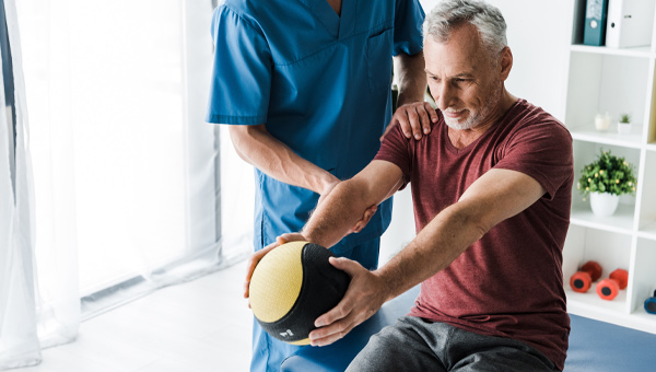 Man working out with an orthopedic therapist