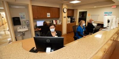 Staff at BayCare Alliant Hospital Front desk staff working behind a desk at BayCare Alliant Hospital.
