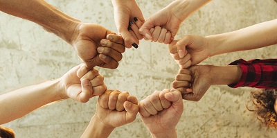 Group of people making fist bump