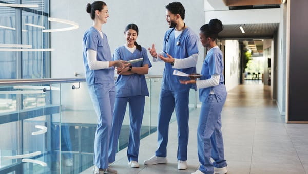 Medical students talking in hallway.