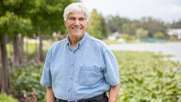 Older man outside smiling for photograph