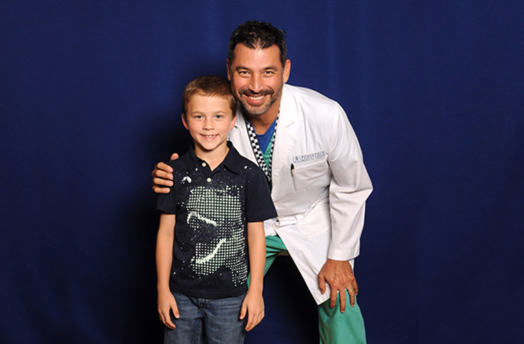 Dr. Alfonso Vargas, medical director of St. Joseph's Women's Hospital's Therapeutic Hypothermia Program with 10-year-old Titan, the first patient to undergo cooling therapy at the hospital.