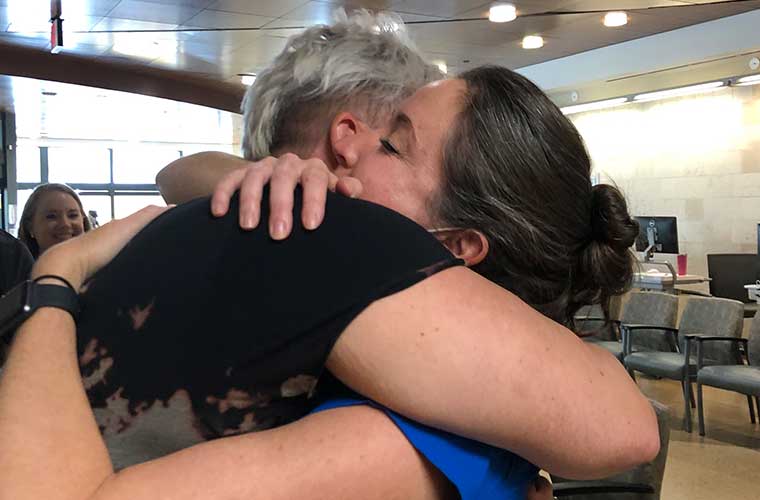 Lara Warn hugs St. Anthony's Hospital emergency center nurse Carly Trowell.