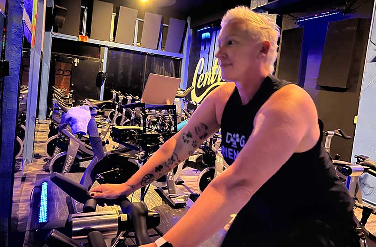 Lara Warn trains indoors on a stationary bike.