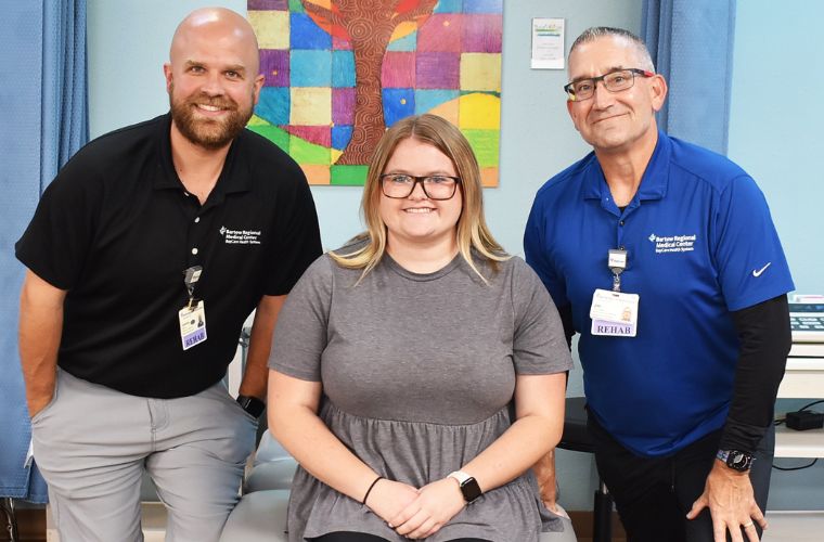 Patient Bailey Caustic poses for a photo with Josh Adlam and Jim Goodwin.