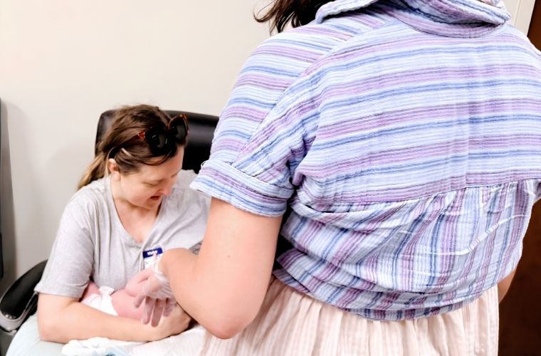 A Baby Café lactation consultant provides one-on-one support to a mother holding an infant during a session at Mease Countryside Hospital.