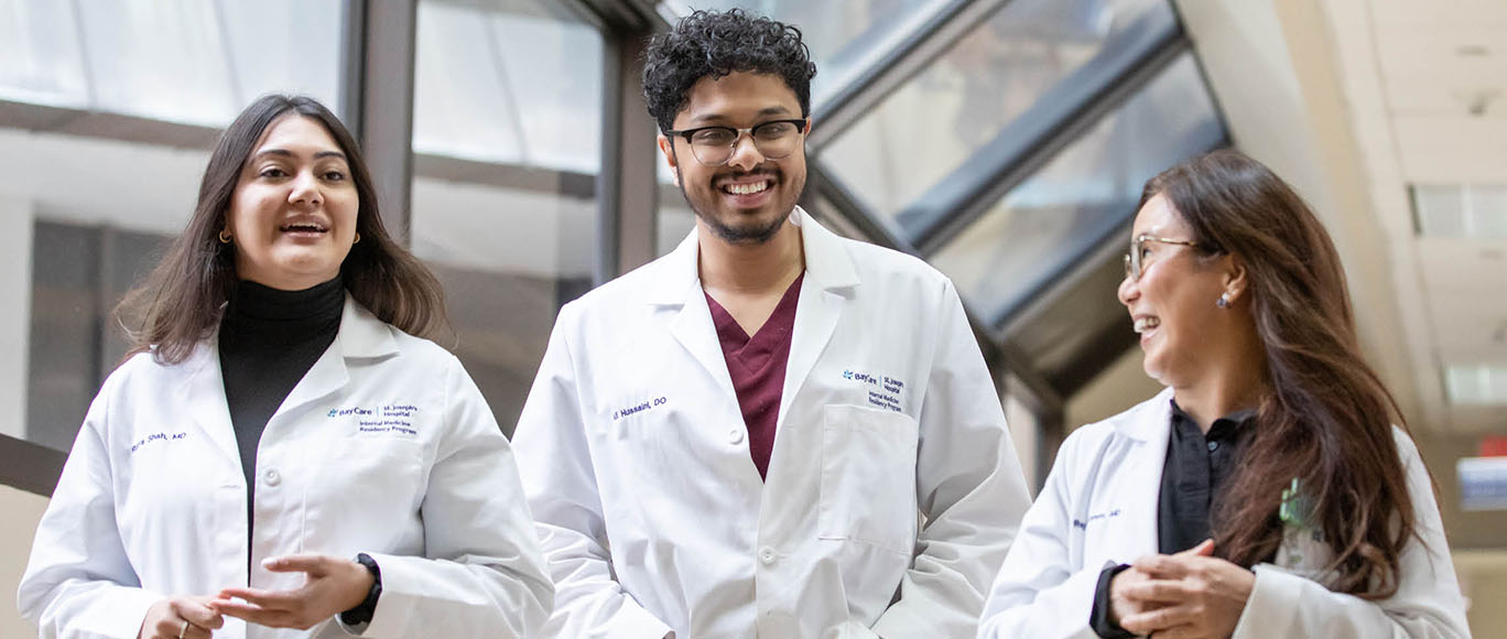 Three BayCare residents walk through the halls of the hospital.