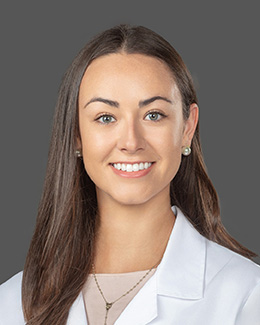 Dr. Christina Rolquin's headshot in a lab coat 