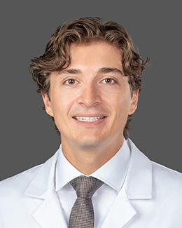 Dr. Teo Fritzke's headshot wearing a lab coat 