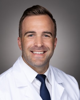 Headshot of Dr. Joshua Bertollo in a lab coat 