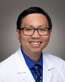 Dr. Tam Huynh's headshot wearing a lab coat 