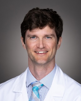 Dr. Brian Stephenson's headshot wearing a lab coat 