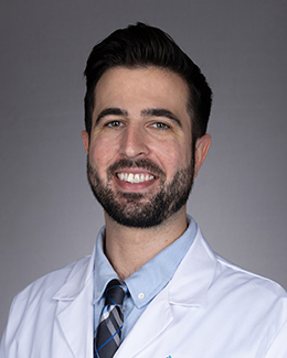 Collin Payne headshot in a lab coat 