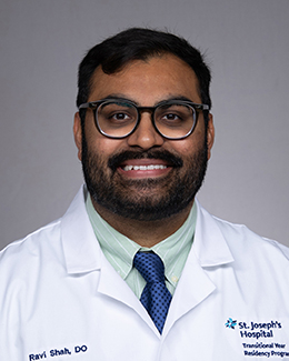 Ravi Shah headshot in a lab coat 