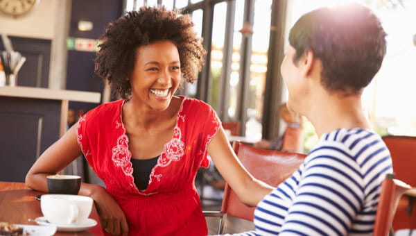 Two women having a conversation in a coffee shop