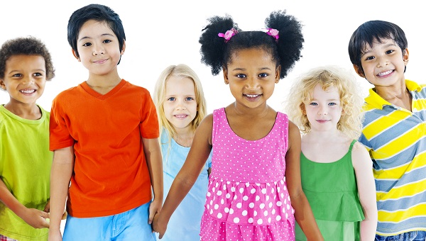 A group of boys and girls are holding hands and smiling.
