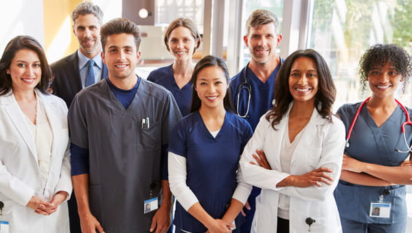 a team of doctors smiling for a group photo