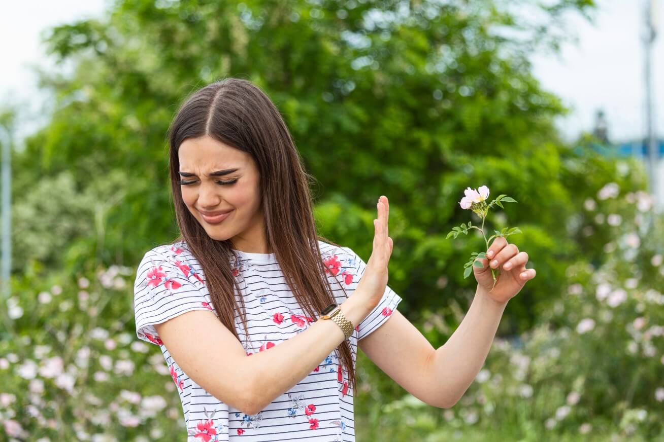 Lady avoiding flowers
