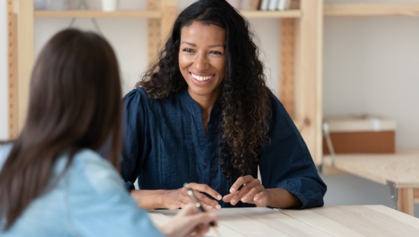 Learn About BayCare Behavioral Health Two professional women sitting while having a conversation in an office