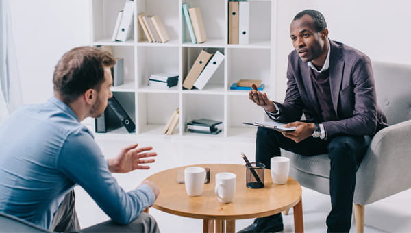 Male counselor talking with a male patient.