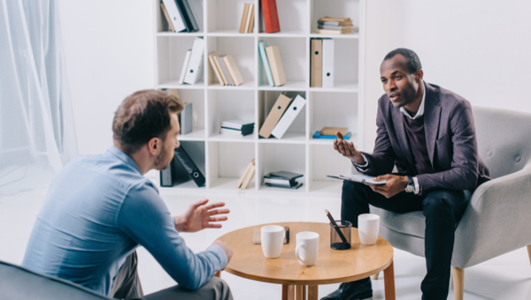 A male patient talks with a male doctor.