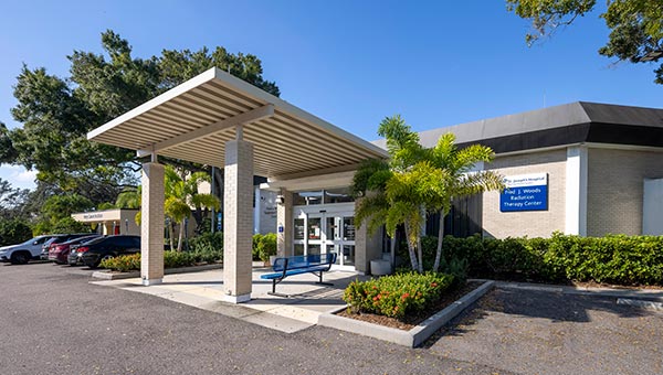 An exterior view of the Fred J. Woods proton therapy center building.