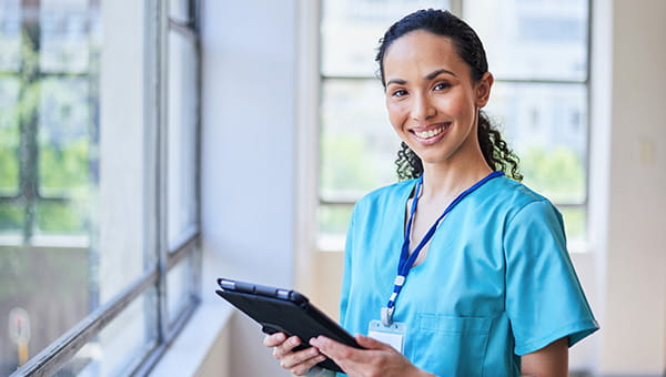 Smiling nurse with an ipad