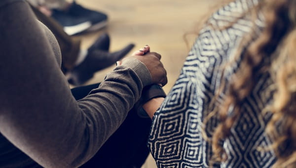 Two people are holding hands.