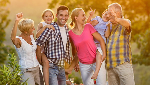 A family of grandparents, parents and two children are enjoying the outdoors together.