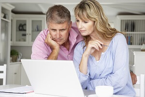 husband and wife looking at laptop