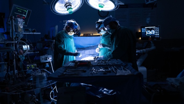 Three surgeons performing open-heart surgery