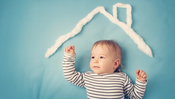 Baby boy with the shape of a house above him