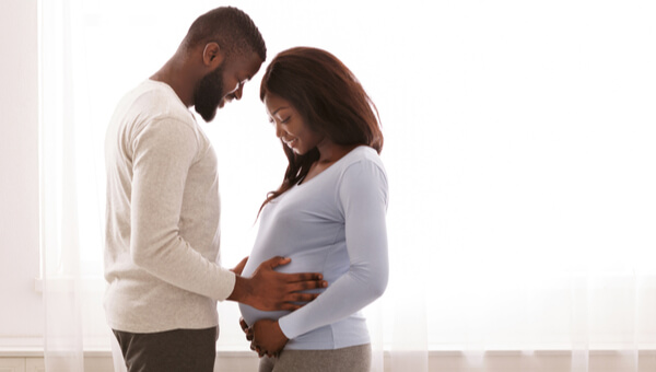 Young male holding pregnant female