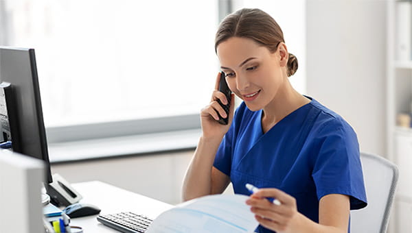 Nurse Navigator talking with patient on the phone.