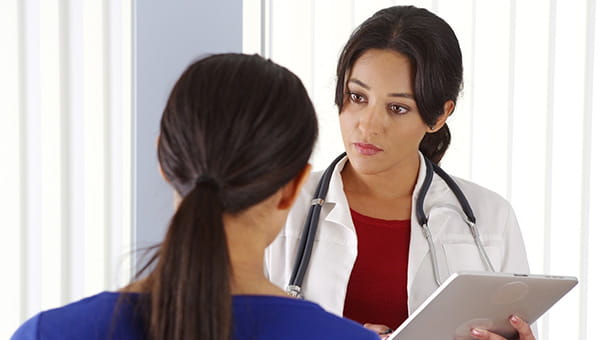 A female doctor talking to a patient